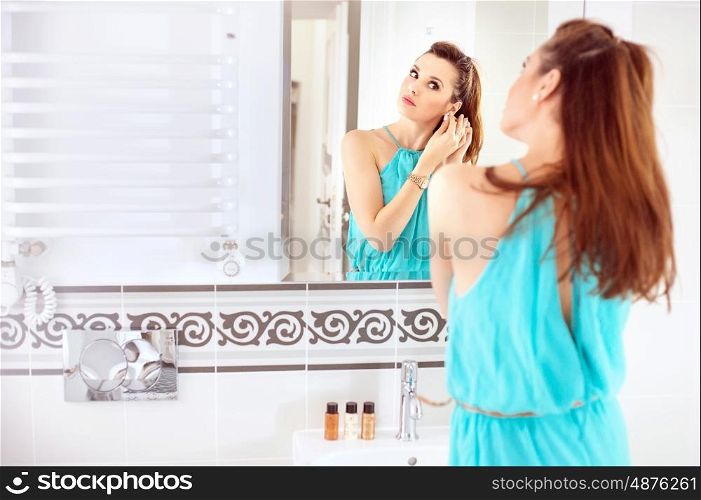 Pretty lady doing a make-up in the bathroom