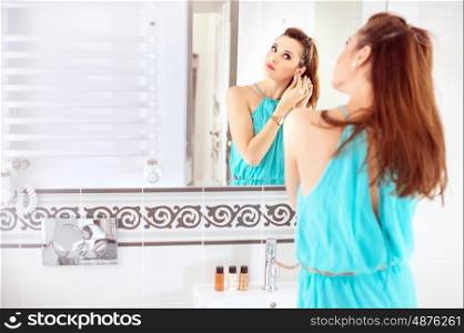 Pretty lady doing a make-up in the bathroom