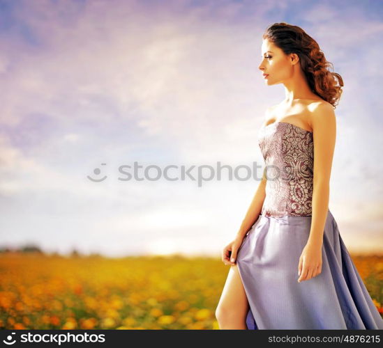 Pretty lady walking on the rural meadow