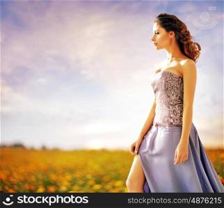 Pretty lady walking on the rural meadow