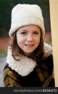 Pretty little girl in the street with wool hat