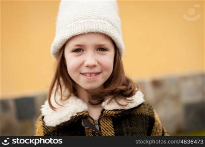 Pretty little girl in the street with wool hat