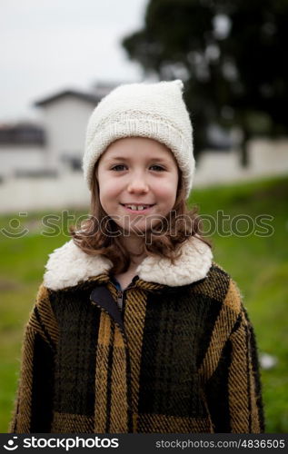 Pretty little girl in the street with wool hat