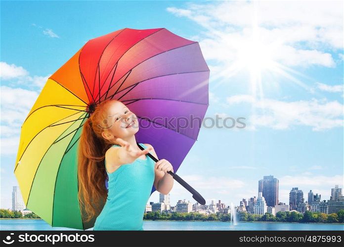 Pretty little girl with a colorful umbrella