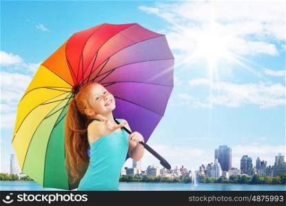 Pretty little girl with a colorful umbrella
