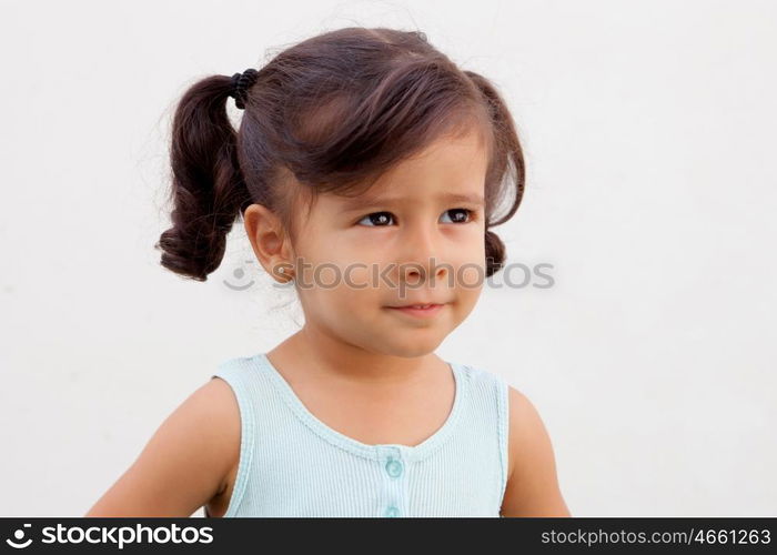 Pretty little girl with blue dress looking up outdoor