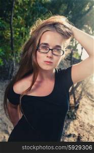 Pretty long haired female posing in fashion style in glasses