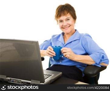 Pretty, mature businesswoman enjoying a cup of coffee at work. Isolated on white.
