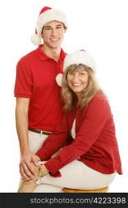 Pretty mature mother and young adult son posing for a Christmas portrait. Isolated on white.