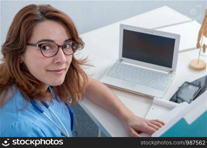 pretty medical woman doctor working with laptop