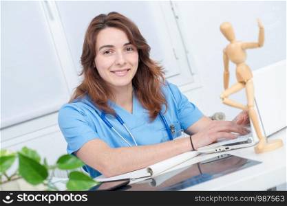 pretty medical woman doctor working with laptop