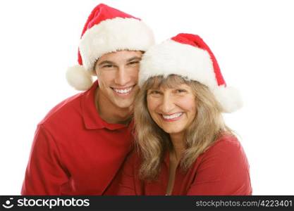 Pretty middle aged mom and her handsome late teen son wearing Santa hats. Isolated on white.