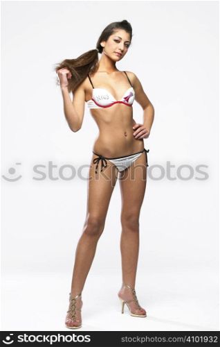 Pretty model wearing bikini on white isolated background