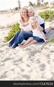 Pretty Mom and Her Cute Daughters Portrait at The Beach.