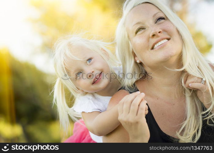 Pretty Mother and Little Girl Having Fun Together in the Grass.