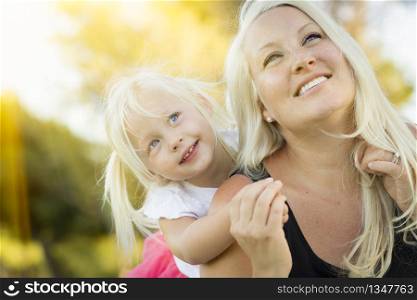 Pretty Mother and Little Girl Having Fun Together in the Grass.