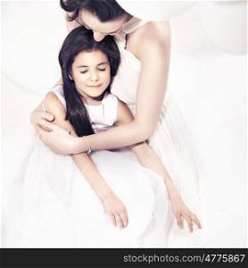 Pretty mother hugging her lovely daughter
