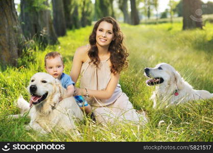 Pretty mother with little child and dogs