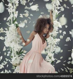 Pretty mulatto lady among white petals