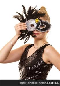 Pretty mysterious woman wearing black carnival mask with feathers. Female being ready for party.. Mysterious woman wearing carnival mask
