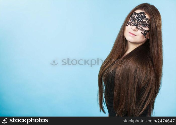 Pretty mysterious woman wearing black eye lace mask having long brown hair.. Mysterious woman wearing lace mask