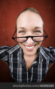 Pretty nerd woman in plaid bluse and glasses