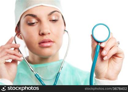 pretty nurse wearing a surgery dress with cap with a stethoscope . focus on hand