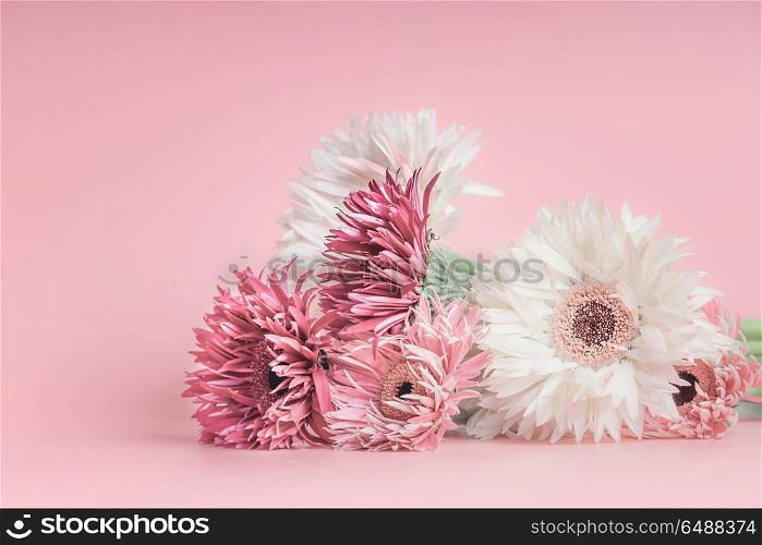 Pretty pastel flowers bunch on pink background.