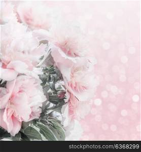 Pretty pastel pink peonies floral border with bokeh. Layout or greeting card for Mothers day, wedding or happy event