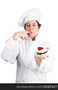 Pretty pastry cook in chef&rsquo;s whites tasting a delicious chocolate cheesecake tart with whipped cream and a cherry on top. Isolated on white background.