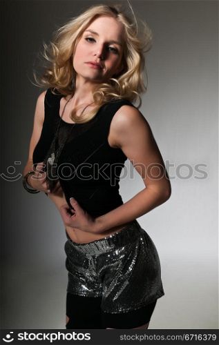 Pretty petite blonde in a black top and torn leggings