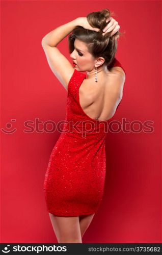 Pretty petite brunette in a red sequined dress