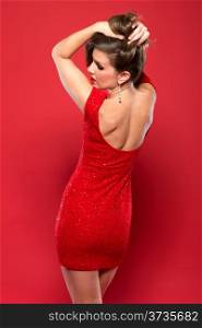 Pretty petite brunette in a red sequined dress