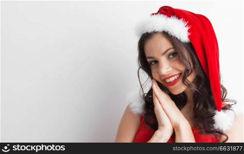 Pretty Pin-up style Santa girl in red hat on white background. Pin-up Santa girl