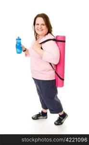 Pretty plus sized model on her way to the gym with yoga mat and water bottle. Full body isolated on white.