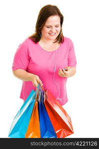 Pretty plus-sized woman holding her shopping bags and listening to music. Isolated on white.