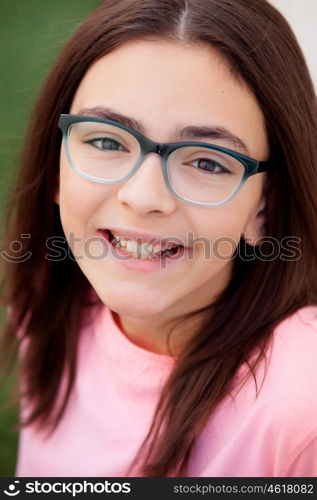 Pretty preteenager girl twelve years old with glasses outside