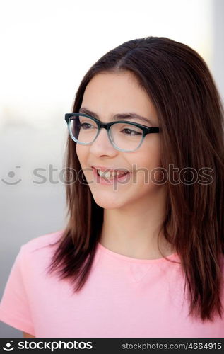 Pretty preteenager girl twelve years old with glasses outside