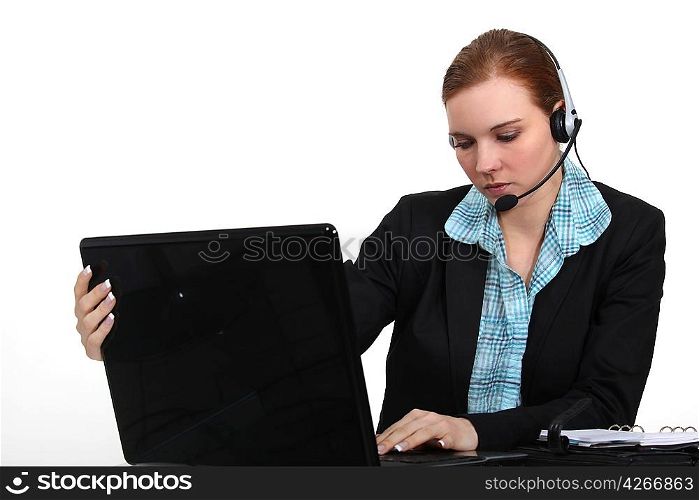 pretty receptionist with laptop and headset