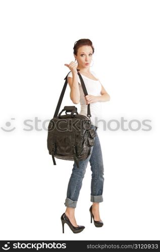 Pretty redhead girl in her 20&rsquo;s hitchhiking with a bag hanging from her shoulder.