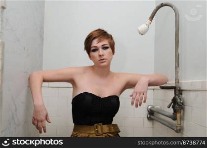 Pretty redhead posing in an old men&rsquo;s room
