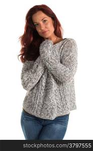 Pretty redheaded woman in a gray sweater and jeans