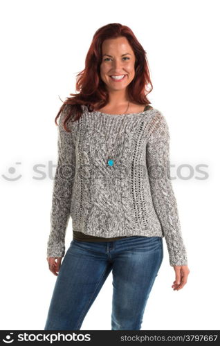 Pretty redheaded woman in a gray sweater and jeans