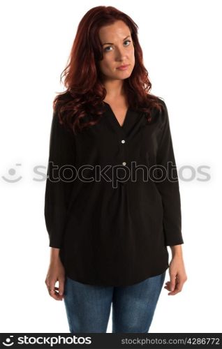 Pretty redheaded woman in a purple blouse and jeans