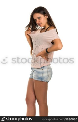 Pretty Romanian brunette in a pink tee shirt and denim shorts