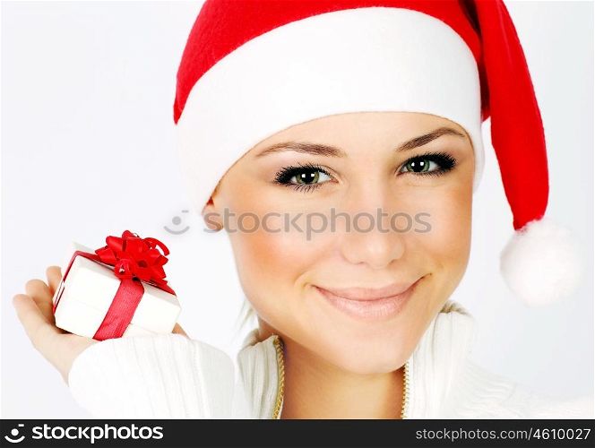 Pretty Santa girl closeup portrait, holding present gift box isolated on white background