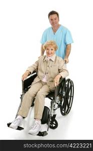 Pretty senior in wheelchair being pushed by a doctor or male nurse. Full body isolated.