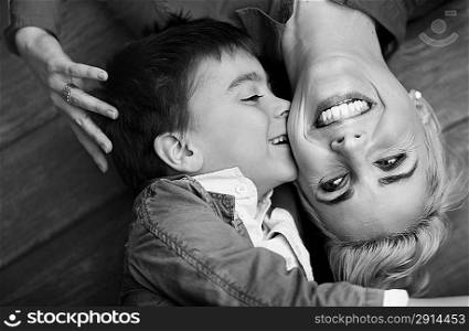 Pretty shot of cute boy kissing his mother