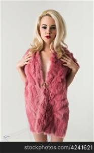 Pretty slender blonde in a fake fur coat