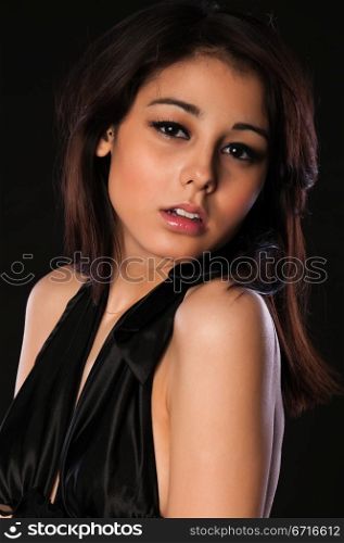 Pretty slender multiracial brunette in black lingerie
